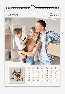 A calendar template with a light starry background featuring photos of a young family and their son with torn edges and a framed wall photo.