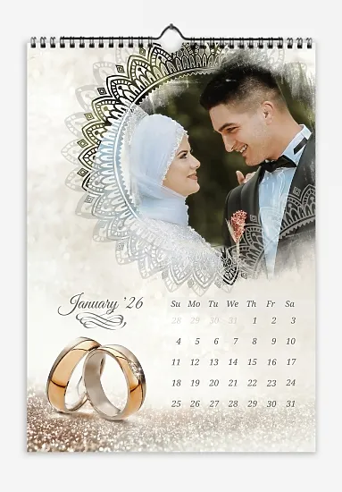 Our wedding calendar template with glittery wedding rings in the background. Photos from a past wedding are framed in an ornate circle with ornate font.
