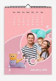 A happy young family with a little son, cats, and balloons on a pink background. Cartoon fonts.